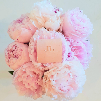 Moisturising Shampoo bar for dry damaged or curly hair sat on pink Peony flowers 